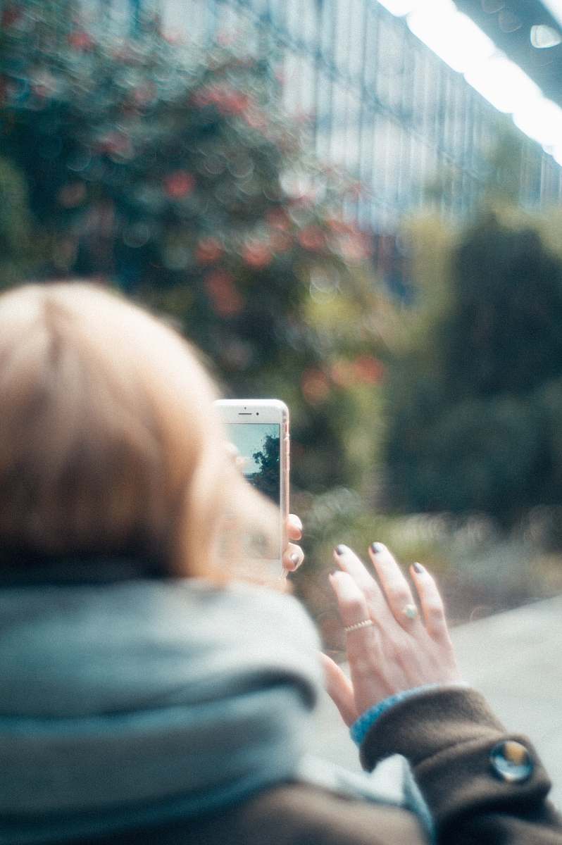 cell phone person holding white iPhone close-up photography mobile phone